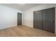 This bedroom features beautiful light hardwood floors and a closet with sliding doors at 2902 E Pierson St, Phoenix, AZ 85016