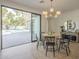 Cozy dining area with a round table, modern chandelier, and sliding doors to the backyard at 2902 E Pierson St, Phoenix, AZ 85016