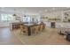 Open-concept dining area with modern light fixtures, a brick accent wall, and wood floors at 2902 E Pierson St, Phoenix, AZ 85016