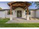 Inviting front entrance with a covered porch, stone columns, and a glass front door at 2902 E Pierson St, Phoenix, AZ 85016