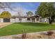 Well-maintained front yard with lush green lawn and a charming single-story home in the background at 2902 E Pierson St, Phoenix, AZ 85016