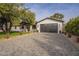 Spacious two-car garage with a black door and a paved driveway at 2902 E Pierson St, Phoenix, AZ 85016