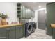 This laundry room includes cabinets, shelving, and a countertop perfect for folding clothes at 2902 E Pierson St, Phoenix, AZ 85016