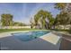 This pool features a modern concrete pool deck and a large grassy area for recreation at 2902 E Pierson St, Phoenix, AZ 85016