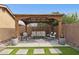 Charming backyard patio featuring a cozy seating area under a wooden pergola, perfect for outdoor gatherings at 3023 E John Cabot Dr, Phoenix, AZ 85032