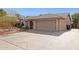 Exterior shot featuring a two-car garage, neutral stucco and a well-maintained front yard at 3023 E John Cabot Dr, Phoenix, AZ 85032