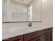 Bathroom vanity with a modern white countertop, dark brown cabinets and a large mirror at 3025 W Night Owl Ln, Phoenix, AZ 85085