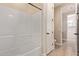 Bathroom with a bathtub and shower combination, a white door and tile flooring at 3025 W Night Owl Ln, Phoenix, AZ 85085