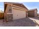 Spacious two-car garage with brick driveway and desert landscaping at 3025 W Night Owl Ln, Phoenix, AZ 85085