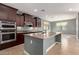 Modern kitchen with stainless steel appliances, granite counters, and a central island at 3025 W Night Owl Ln, Phoenix, AZ 85085