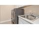 Laundry room featuring modern appliances, upper cabinets and a utility sink at 3025 W Night Owl Ln, Phoenix, AZ 85085