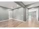 Open living room with wood-look floors and neutral gray paint at 3025 W Night Owl Ln, Phoenix, AZ 85085