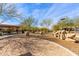 Sand-covered play area with dinosaur-themed climbing structures at 3025 W Night Owl Ln, Phoenix, AZ 85085