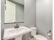 This powder room features gray walls, a decorative mirror, and a pedestal sink at 3025 W Night Owl Ln, Phoenix, AZ 85085