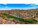 Scenic aerial view of a residential neighborhood with a lush green golf course and mountain backdrop at 3400 E Isaiah Ave, Gilbert, AZ 85298