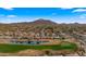 Picturesque aerial view of a neighborhood with golf course, pond, and mountain views at 3400 E Isaiah Ave, Gilbert, AZ 85298