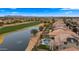 Stunning aerial view of a lakeside home with a private pool and well-manicured landscaping near a golf course at 3400 E Isaiah Ave, Gilbert, AZ 85298