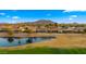 Breathtaking view of a neighborhood lake and golf course against a mountainous backdrop at 3400 E Isaiah Ave, Gilbert, AZ 85298