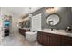 This bathroom features a soaking tub, tile flooring, and modern vanities at 3400 E Isaiah Ave, Gilbert, AZ 85298