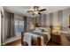 Cozy bedroom with wood floors, a ceiling fan, and striped accent wall at 3400 E Isaiah Ave, Gilbert, AZ 85298