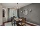 Stylish dining room featuring modern lighting, a rustic wood table, and elegant decor at 3400 E Isaiah Ave, Gilbert, AZ 85298