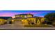 Illuminated front exterior of a two-story home featuring desert landscaping, a three-car garage, and a welcoming entryway at 3400 E Isaiah Ave, Gilbert, AZ 85298