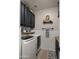 Well-organized laundry room with modern washer and dryer, stylish cabinets, and decorative accents at 3400 E Isaiah Ave, Gilbert, AZ 85298