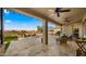 Relaxing outdoor patio with stone flooring, lounge seating, outdoor ceiling fans, and a view of the pool at 3400 E Isaiah Ave, Gilbert, AZ 85298