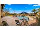 Outdoor patio with checker table and chairs, alongside a pool with a pink flamingo, perfect for relaxation at 3400 E Isaiah Ave, Gilbert, AZ 85298