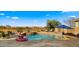 Inviting pool area features a spa, lounge chairs, an umbrella, and a playful flamingo float at 3400 E Isaiah Ave, Gilbert, AZ 85298