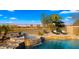 Luxury backyard featuring a pool, spa, waterfall, lounge chairs, lake views and an entertainment set at 3400 E Isaiah Ave, Gilbert, AZ 85298