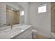 Stylish bathroom with marble countertops, modern fixtures, and a soaking tub at 34315 N Sandpiper Trl, Queen Creek, AZ 85144