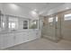 Luxurious primary bathroom with double vanity, glass enclosed shower and modern fixtures at 34315 N Sandpiper Trl, Queen Creek, AZ 85144