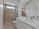 Sleek bathroom features marble countertop, tile flooring, and glass shower door at 34315 N Sandpiper Trl, Queen Creek, AZ 85144