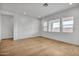 Empty bedroom featuring hardwood floors, white paint, and natural light at 34315 N Sandpiper Trl, Queen Creek, AZ 85144