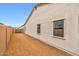 Exterior shot of a home showcasing the wall, windows, and adjacent walkway at 34315 N Sandpiper Trl, Queen Creek, AZ 85144