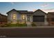 Stunning single-story home with modern architectural details, desert landscaping, and a stylish gray door at 34315 N Sandpiper Trl, Queen Creek, AZ 85144