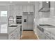 Kitchen featuring stainless steel appliances, an island with sink, and custom white cabinetry at 34315 N Sandpiper Trl, Queen Creek, AZ 85144