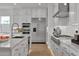 Kitchen featuring stainless steel appliances, an island with sink, and custom white cabinetry at 34315 N Sandpiper Trl, Queen Creek, AZ 85144