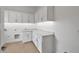 Laundry room with white cabinets, countertop space, and sink for cleaning convenience at 34315 N Sandpiper Trl, Queen Creek, AZ 85144