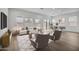 Bright and airy living room featuring hardwood floors, modern furniture, and large windows at 34315 N Sandpiper Trl, Queen Creek, AZ 85144