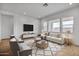 Staged living room with neutral decor and ample natural light at 34315 N Sandpiper Trl, Queen Creek, AZ 85144