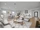 Staged living room with a spacious layout and white furnishings at 34315 N Sandpiper Trl, Queen Creek, AZ 85144