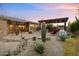 Desert landscaped backyard features an outdoor kitchen, pergola and decorative rock stream at 34801 N 53Rd St # 2, Cave Creek, AZ 85331