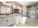 Elegant bathroom with soaking tub, dual vanities, and glass-enclosed shower at 34801 N 53Rd St # 2, Cave Creek, AZ 85331