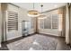 Open-concept dining room with modern chandelier and large windows providing natural light at 34801 N 53Rd St # 2, Cave Creek, AZ 85331