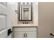 Powder room with decorative mirror, granite countertop, and white cabinetry at 34801 N 53Rd St # 2, Cave Creek, AZ 85331