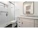 Modern bathroom with white vanity, glass shower, sleek fixtures, and black tiled flooring at 3538 E Glenrosa Ave, Phoenix, AZ 85018