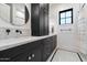 Chic bathroom featuring marble counters, black cabinets, modern fixtures, and tiled floors at 3538 E Glenrosa Ave, Phoenix, AZ 85018