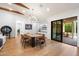 Dining room with hardwood floors, modern lighting, and views to the outdoor patio at 3538 E Glenrosa Ave, Phoenix, AZ 85018